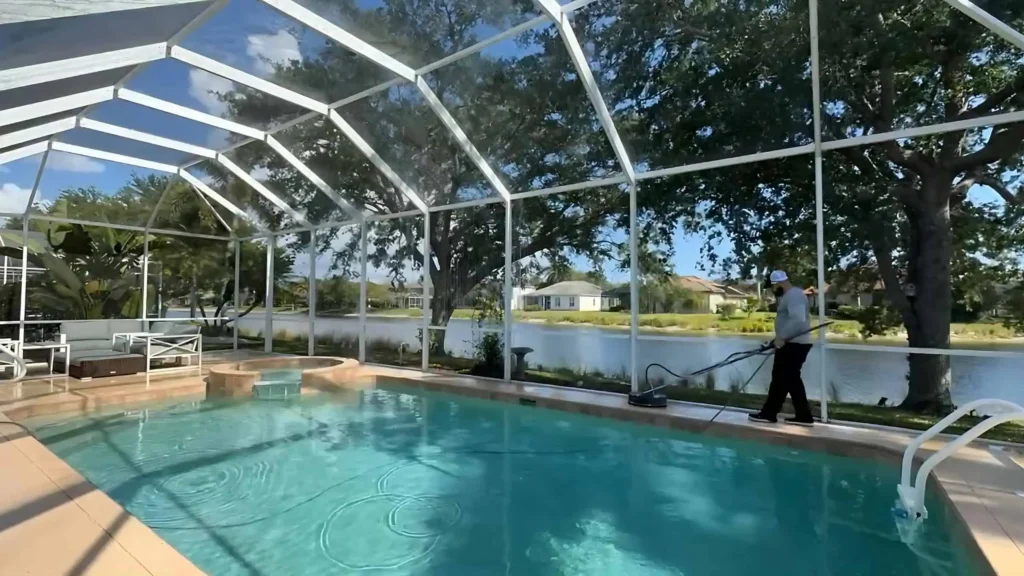 "a man pressure cleaning a pool deck with a surface cleaner machine"